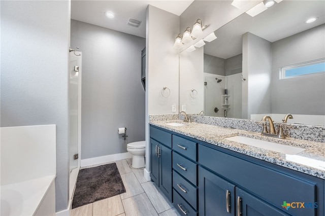 full bathroom featuring vanity, separate shower and tub, and toilet