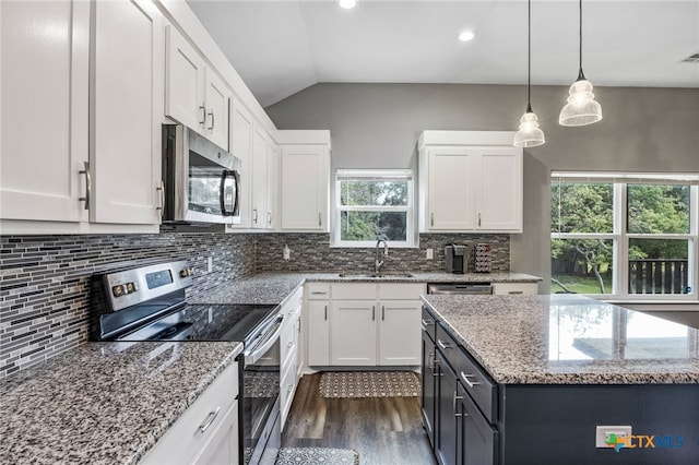 kitchen with appliances with stainless steel finishes, white cabinetry, and sink