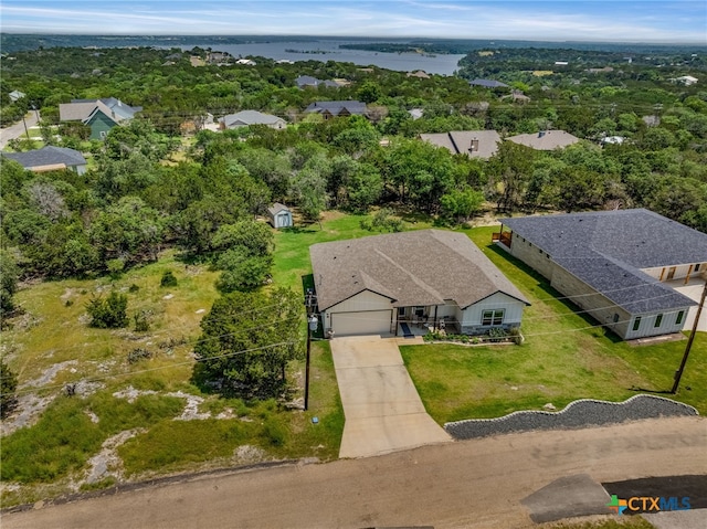 birds eye view of property with a water view