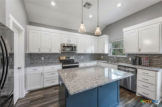 kitchen with pendant lighting, a center island, sink, white cabinetry, and stainless steel appliances