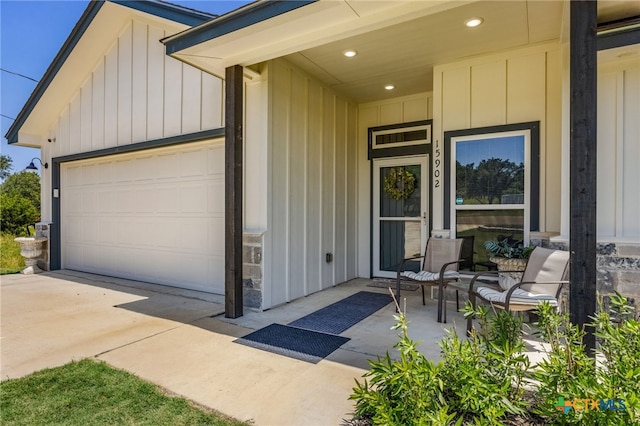 doorway to property with covered porch and a garage