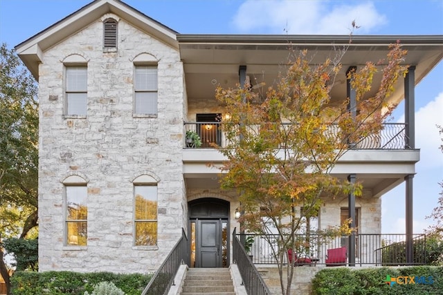 view of front of property with a balcony