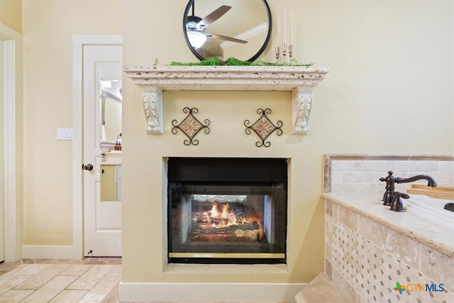 details featuring ceiling fan and crown molding