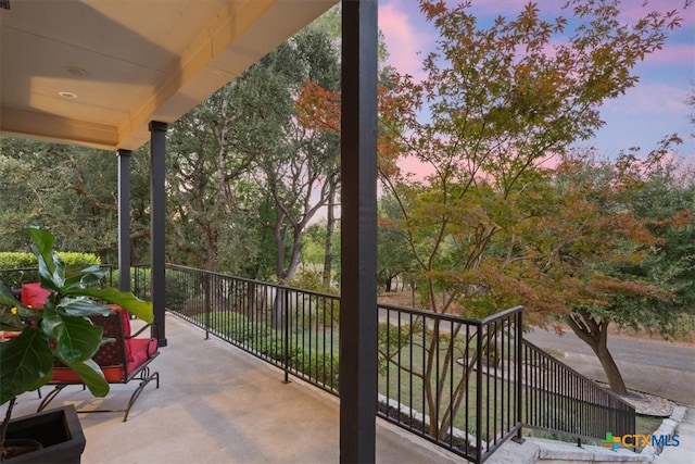 view of balcony at dusk