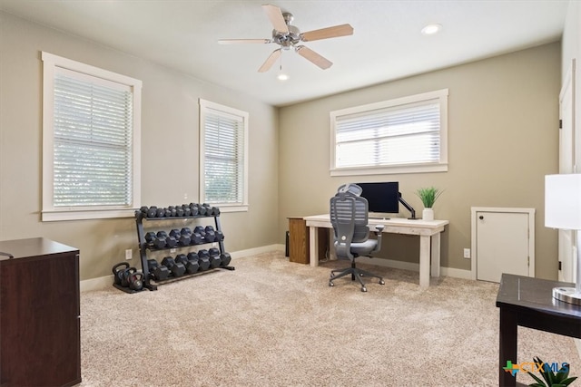 carpeted home office with ceiling fan