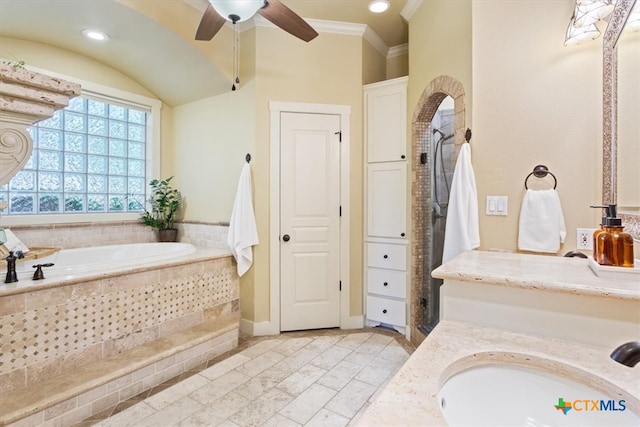 bathroom with tiled bath, ceiling fan, vanity, and ornamental molding