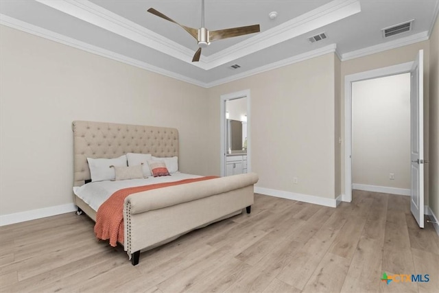 bedroom with ceiling fan, ornamental molding, a raised ceiling, and light hardwood / wood-style floors