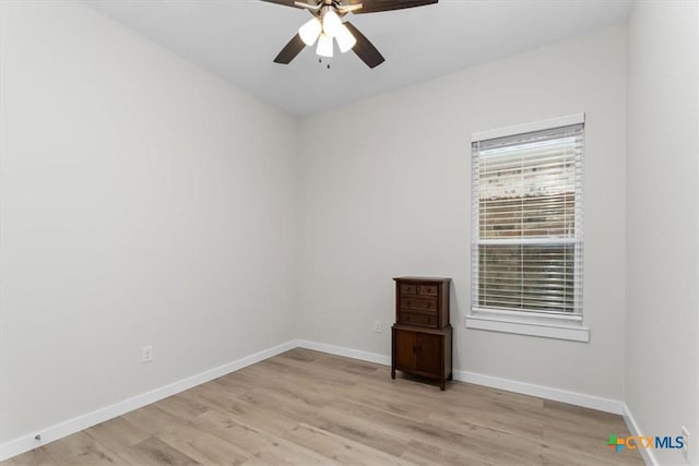 empty room with a ceiling fan, baseboards, and light wood-type flooring