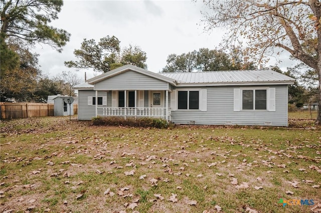 view of front of home featuring a storage shed, a front lawn, and a porch