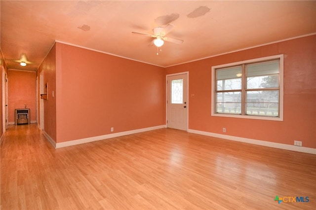 interior space with ornamental molding, light hardwood / wood-style floors, and ceiling fan