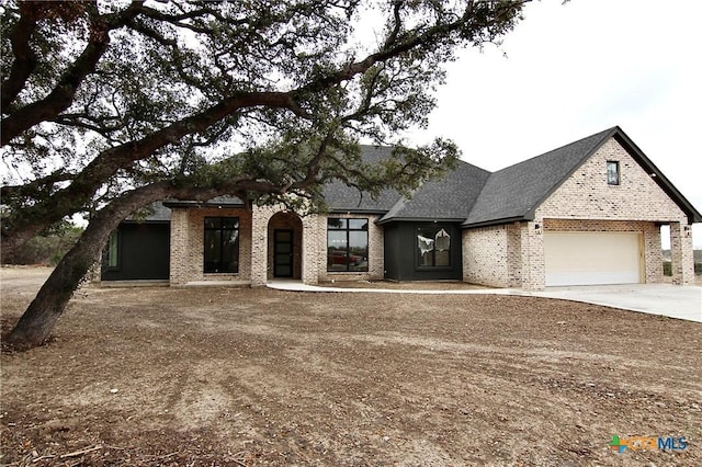 french provincial home with a garage