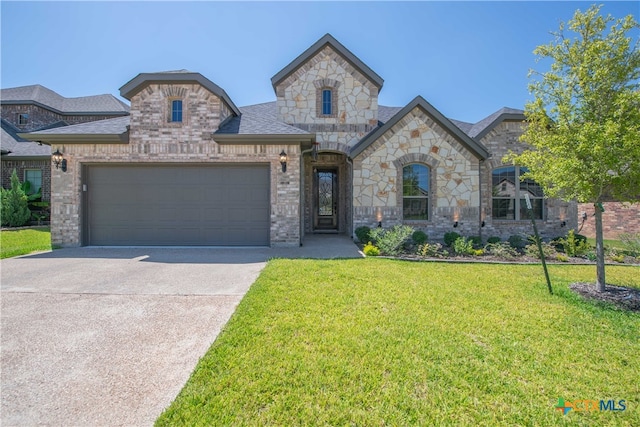 french provincial home with a garage and a front lawn