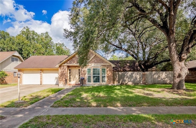 view of front of home with a front lawn and a garage