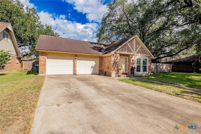 view of front of house featuring a front lawn and a garage