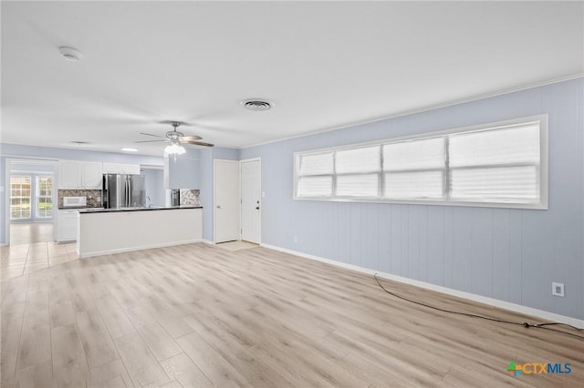 unfurnished living room with ceiling fan and light hardwood / wood-style floors