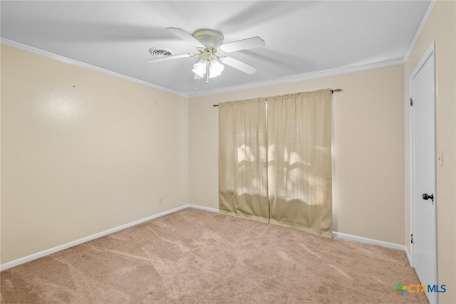 empty room with ceiling fan, crown molding, and carpet