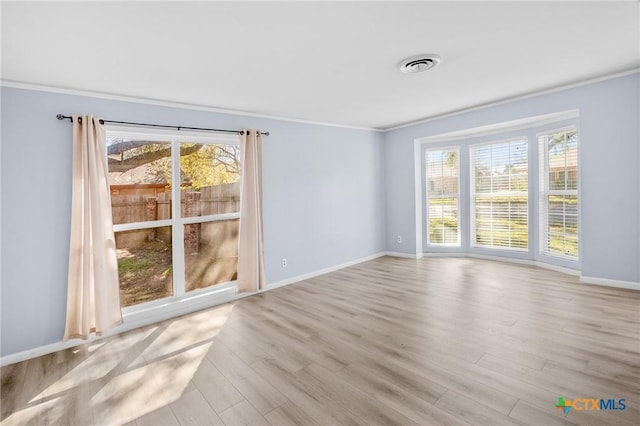 unfurnished room with crown molding and light hardwood / wood-style flooring