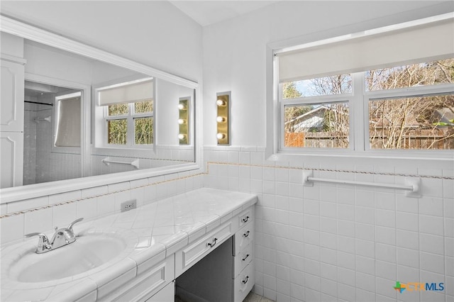 bathroom featuring tile walls and vanity