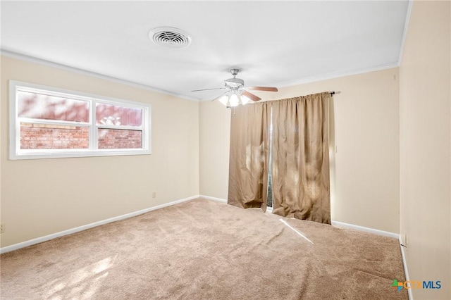 carpeted empty room with ceiling fan and crown molding