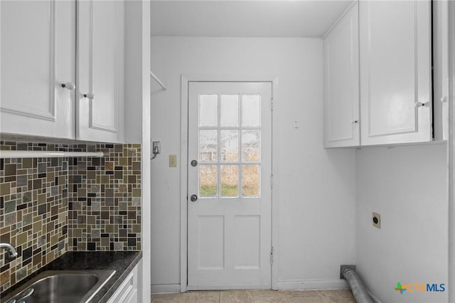 washroom with sink, cabinets, light tile patterned flooring, and electric dryer hookup