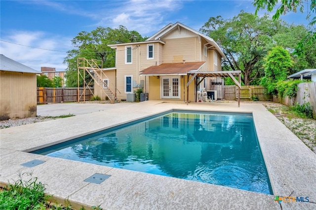 214 Hubbard St, Yoakum, TX 77995 - rear view of property featuring french doors, a patio, a fenced backyard, and a pergola