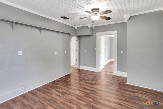 214 Hubbard St, Yoakum, TX 77995 - unfurnished room featuring arched walkways, ornamental molding, ceiling fan, wood finished floors, and baseboards