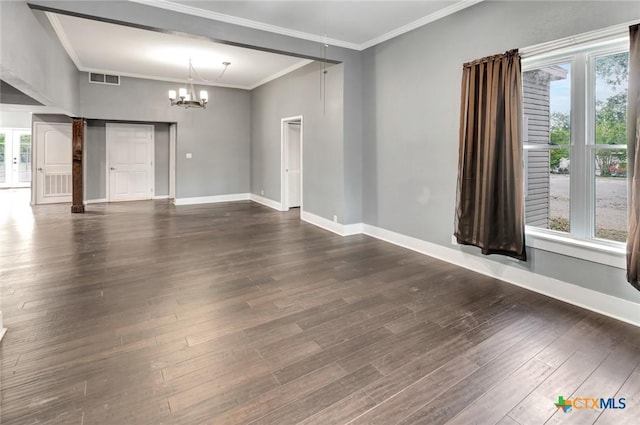214 Hubbard St, Yoakum, TX 77995 - unfurnished room featuring plenty of natural light, a chandelier, dark wood finished floors, ornamental molding, and baseboards