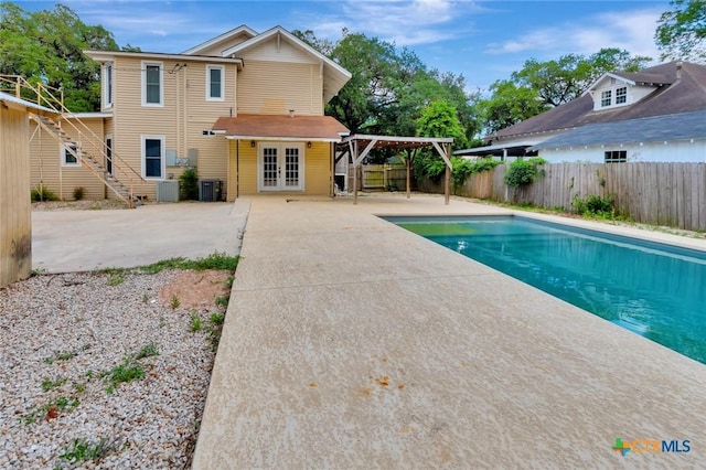 214 Hubbard St, Yoakum, TX 77995 - view of pool with french doors, a fenced backyard, a patio, and central AC
