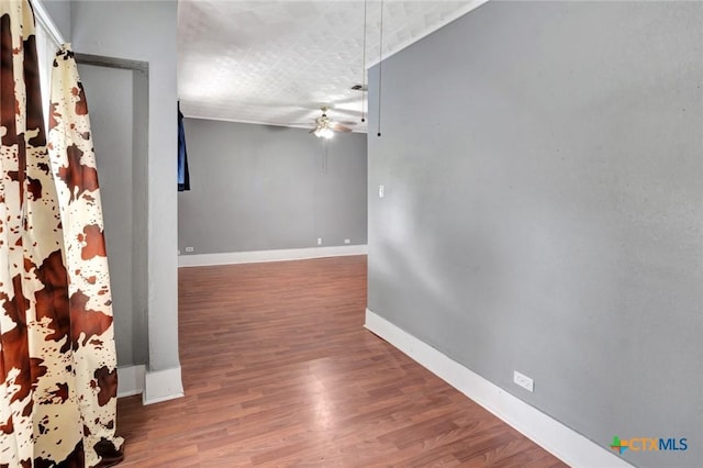 214 Hubbard St, Yoakum, TX 77995 - unfurnished room featuring baseboards, wood finished floors, and ceiling fan