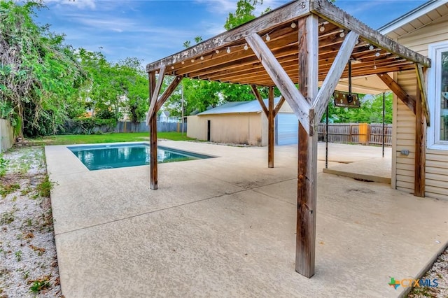 214 Hubbard St, Yoakum, TX 77995 - view of pool with a patio area, a fenced backyard, and an outbuilding