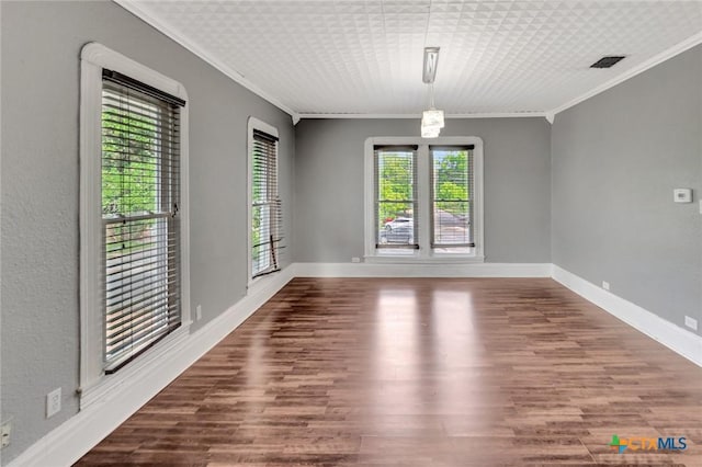 214 Hubbard St, Yoakum, TX 77995 - spare room with ornamental molding, wood finished floors, and baseboards