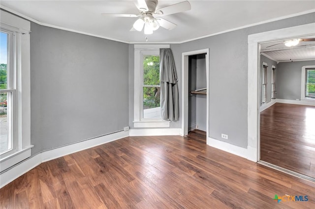214 Hubbard St, Yoakum, TX 77995 - unfurnished bedroom featuring wood finished floors, crown molding, baseboards, and a closet