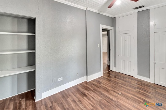 214 Hubbard St, Yoakum, TX 77995 - unfurnished bedroom with a textured wall, crown molding, wood finished floors, baseboards, and a ceiling fan