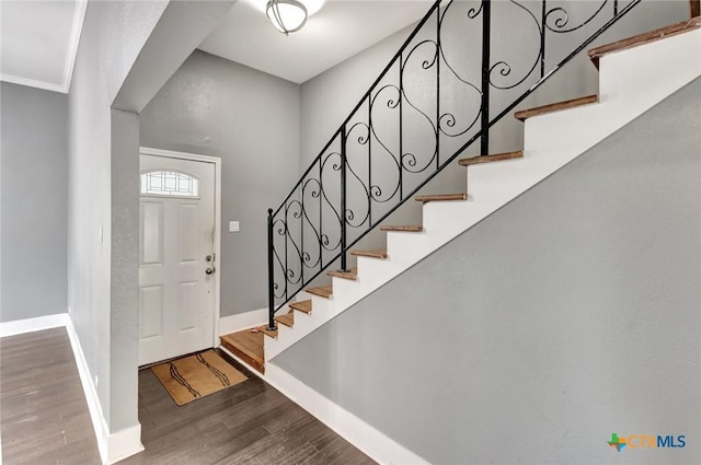 214 Hubbard St, Yoakum, TX 77995 - foyer with stairs, baseboards, and wood finished floors