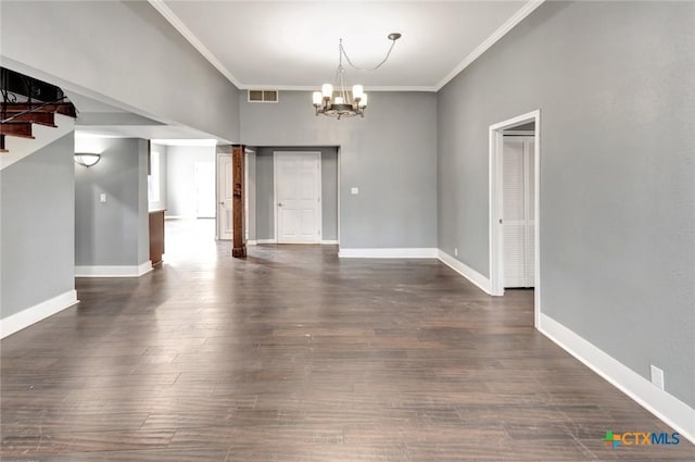 214 Hubbard St, Yoakum, TX 77995 - unfurnished room with a chandelier, crown molding, dark wood-style floors, and baseboards