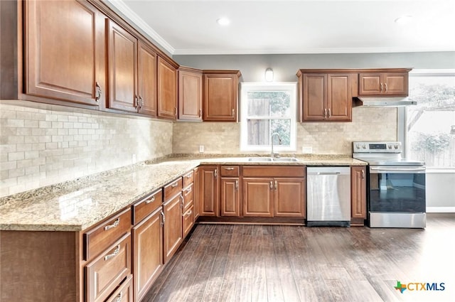 214 Hubbard St, Yoakum, TX 77995 - kitchen with stainless steel appliances, a sink, under cabinet range hood, dark wood-type flooring, and light stone countertops