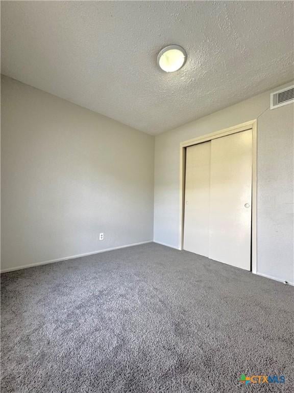 6430 Ridge Village Dr, San Antonio, TX 78233 - unfurnished bedroom featuring carpet, a textured ceiling, and a closet