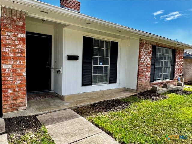 6430 Ridge Village Dr, San Antonio, TX 78233 - view of exterior entry with brick siding and a chimney