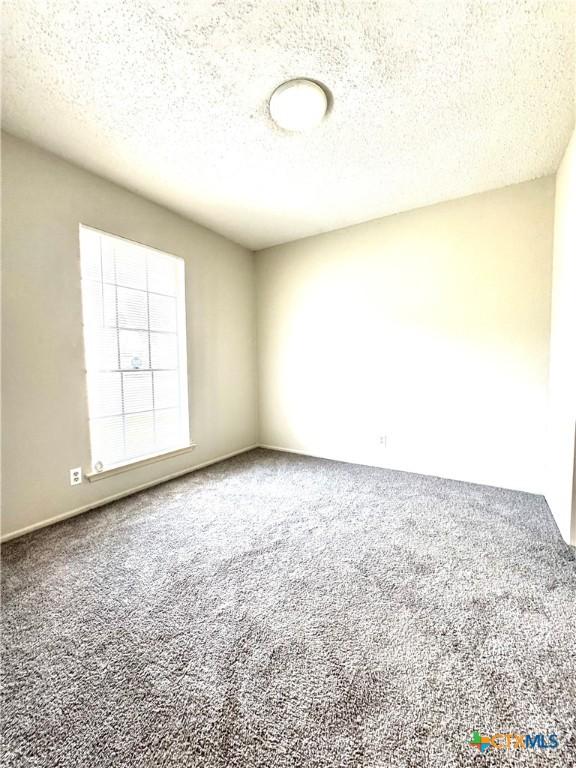 6430 Ridge Village Dr, San Antonio, TX 78233 - empty room with carpet flooring and a textured ceiling
