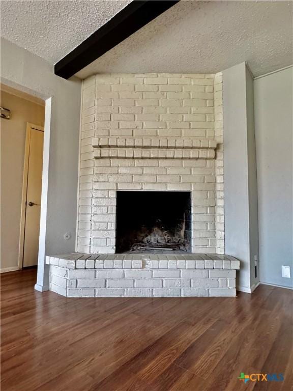 6430 Ridge Village Dr, San Antonio, TX 78233 - detailed view of a textured ceiling, wood finished floors, baseboards, a fireplace, and beamed ceiling