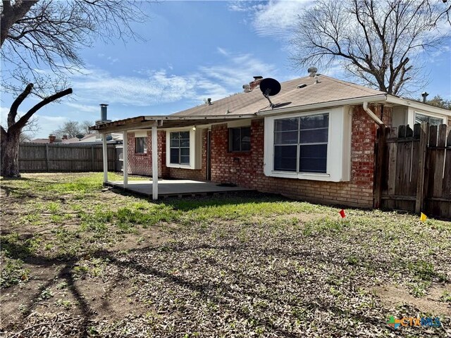 6430 Ridge Village Dr, San Antonio, TX 78233 - rear view of house with brick siding, a patio area, and a fenced backyard