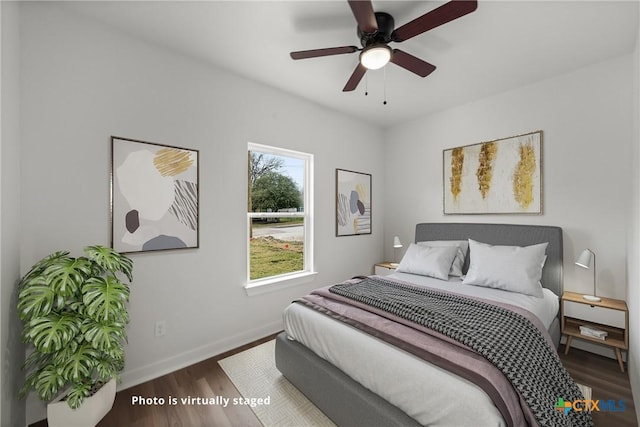 bedroom with ceiling fan and dark wood-type flooring