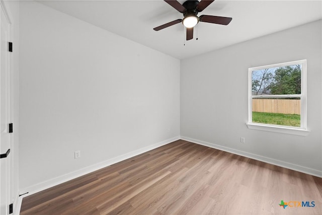 empty room featuring light wood-type flooring and ceiling fan