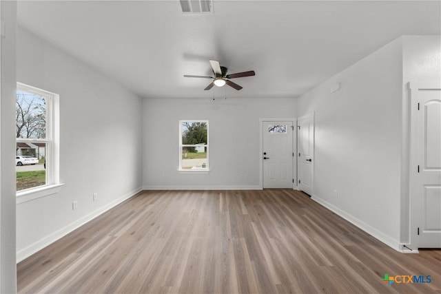 empty room with ceiling fan and light wood-type flooring