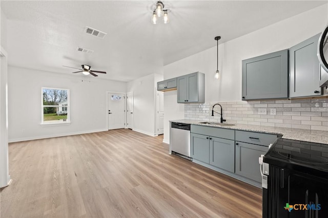 kitchen with dishwasher, sink, ceiling fan, decorative backsplash, and light stone countertops