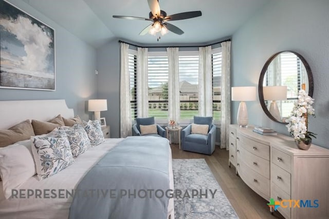 bedroom featuring lofted ceiling, wood finished floors, and ceiling fan