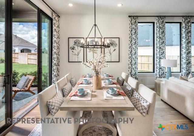 dining room featuring a chandelier, recessed lighting, and wood finished floors