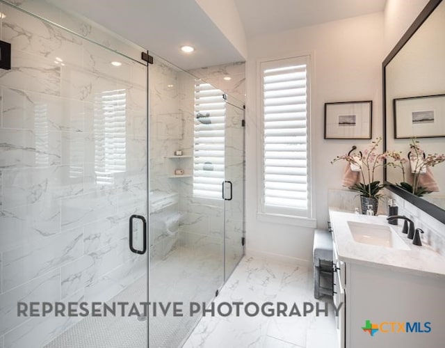 full bath with a marble finish shower, baseboards, recessed lighting, vanity, and marble finish floor