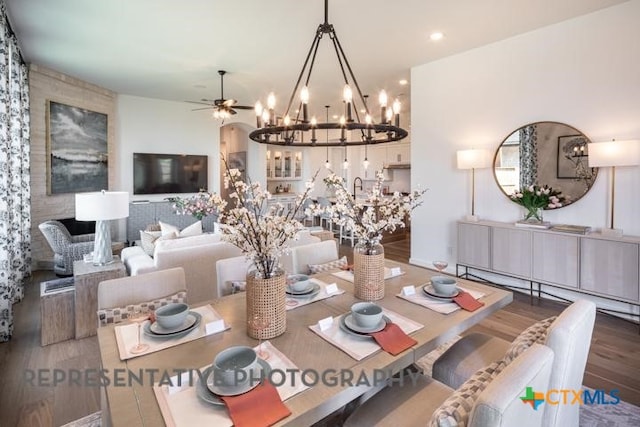 dining space with a baseboard radiator, wood finished floors, recessed lighting, and ceiling fan with notable chandelier