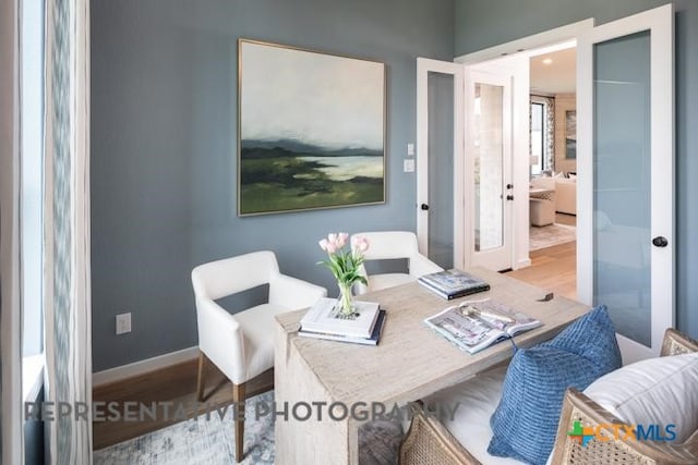 office area with wood finished floors, french doors, and baseboards